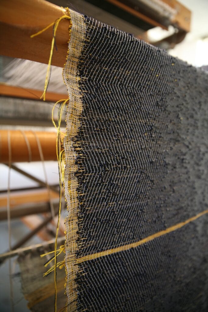 Marianne Kemp - handwoven horsehair weaving fabric dress weaving hanging on loom