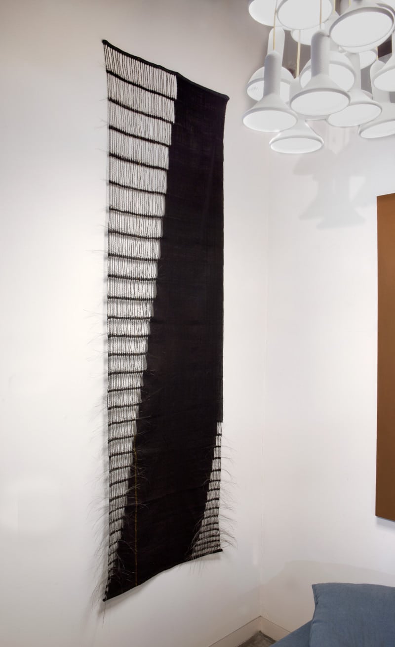 black weaving hanging on wall