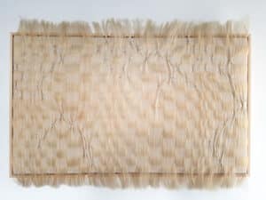 weaving blond horse hair with gold lurex