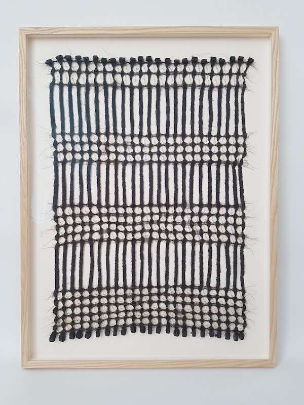 black weaving in wooden frame